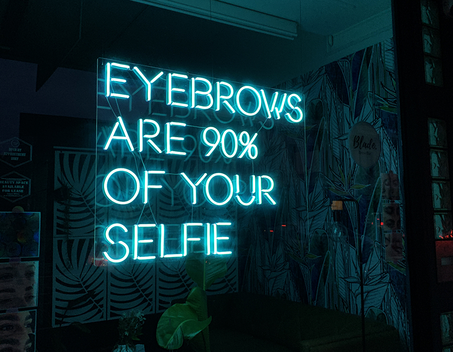 Teal eyebrows are 90% of your selfie neon sign on mirror