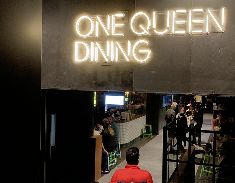 one queen dining yellow neon sign